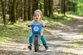 happy kid in forest with balance bike riding fast Royalty Free Stock Photo