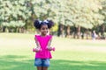 Happy kid girl exercising with dumbbell in park. Active child playing outdoor in the park Royalty Free Stock Photo