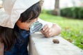 Happy kid girl exploring nature with a magnifying glass and a snail. He having fun in the garden. The concept of the kid is ready Royalty Free Stock Photo