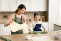 Happy kid girl helping mom to bake, preparing homemade pies Royalty Free Stock Photo