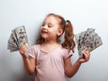 Happy kid girl holding cash dollars and looking with smile Royalty Free Stock Photo