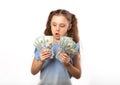 Happy kid girl holding money dollars with surprising emotion and Royalty Free Stock Photo