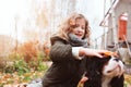 happy kid girl playing with her cavalier king charles spaniel dog in autumn Royalty Free Stock Photo