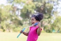 Happy kid girl playing with soap bubbles. Active child playing outdoor in the park Royalty Free Stock Photo