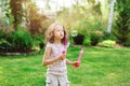 Happy kid girl playing with soap bubbles Royalty Free Stock Photo