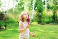 Happy kid girl playing with soap bubbles Royalty Free Stock Photo