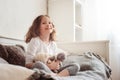 Happy kid girl playing with teddy bears in her room, sitting on bed Royalty Free Stock Photo