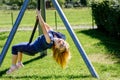 Happy kid girl rids on zip line swing outdoor game play equipment on playground. Child having fun outdoors. Preschool