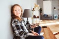 Happy kid girl sitting on table at home and wring. Learning lessons, successfull education Royalty Free Stock Photo