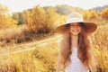 Happy kid girl in straw having fun outdoor on summer sunny field Royalty Free Stock Photo