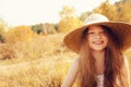 Happy kid girl in straw having fun outdoor on summer sunny field Royalty Free Stock Photo