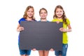 Happy kid girls holding black board copyspace