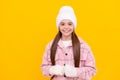 happy kid in hat. female fashion model on yellow background. teen girl in mittens.