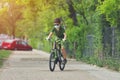 Happy kid having fun near home with a bicycle on beautiful spring day wearing protection mask for coronavirus Covid-19 pandemic Royalty Free Stock Photo