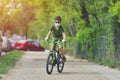 Happy kid having fun near home with a bicycle on beautiful spring day wearing protection mask for coronavirus Covid-19 pandemic Royalty Free Stock Photo