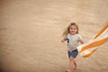 Happy kid having fun. Kid small boy with smiling happy face running along beach Royalty Free Stock Photo