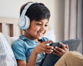 Happy, kid and headphones with tablet in bedroom to watch movies, video game and elearning app. Boy child smile with Royalty Free Stock Photo