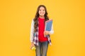 Happy kid hold school books and ripe apple fruit for healthy snacking, snack