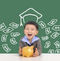 Happy kid holding piggy bank and saving money for education concept Royalty Free Stock Photo