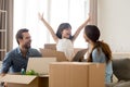 Happy kid jumping out of box laughing packing with parents Royalty Free Stock Photo