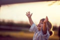 Happy kid looking at the sky . fun on countryside, sunset golden hour. Freedom nature concept Royalty Free Stock Photo