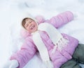 Happy kid lying on snow in winter outdoor Royalty Free Stock Photo