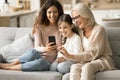 Happy kid, mom and grandma enjoying domestic online communication