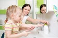 Happy kid with mom washing hands in bathroom Royalty Free Stock Photo