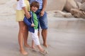 Happy, kid and parents on the beach in summer, holiday or vacation with family in Florida. Excited, child and feet relax Royalty Free Stock Photo