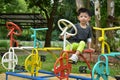 Happy kid playing bicycle stand in outdoor park playground Royalty Free Stock Photo