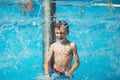 Happy kid playing in blue water of swimming pool on a tropical r Royalty Free Stock Photo