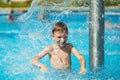 Happy kid playing in blue water of swimming pool on a tropical r Royalty Free Stock Photo