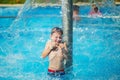 Happy kid playing in blue water of swimming pool on a tropical r Royalty Free Stock Photo