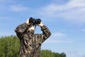 Happy kid playing outdoors with binocular. Travel, holidays adventure concept