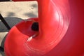 Happy kid playing red slide in sand playground Royalty Free Stock Photo
