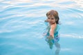 Happy kid playing in swimming pool. Child water games. Family vacation and summer activity. Royalty Free Stock Photo