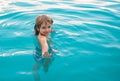 Happy kid playing in swimming pool. Child water games. Family vacation and summer activity. Royalty Free Stock Photo