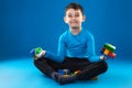 Kid playing toy blocks isolated on the blue background Royalty Free Stock Photo