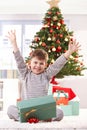 Happy kid raising arms at christmas