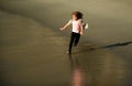 Happy kid running on sea beach. Funny boy run along surf edge. Active kids lifestyle. Little runner exercising. Sporty Royalty Free Stock Photo