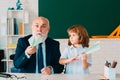 Happy kid in school break. Teacher with pupil with airplanes. Education, teachering, elementary school. Royalty Free Stock Photo