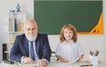 Happy kid in school. Teacher help to learn. Education, teachering, elementary school. Royalty Free Stock Photo