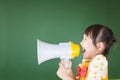 Happy kid shouts something into the megaphone Royalty Free Stock Photo