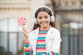 Happy kid singing sweet candy mic. Happy childhood. Kid child headphones holding lollipop candy. Happy kid with candy