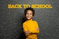 Happy kid student boy on chalkboard background with Back to school inscription and science formulas Royalty Free Stock Photo