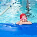 Happy kid in the swimming class in the swimming pool Royalty Free Stock Photo