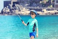 Happy kid taking selfie at beach, smiling little boy having fun in vacation on tropical sea sharing picture on social media Royalty Free Stock Photo