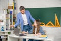 happy kid with teacher in classroom use laptop Royalty Free Stock Photo
