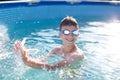 Happy kid with teeth smile splasing in swimming pool Royalty Free Stock Photo