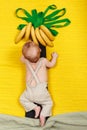 Happy kid wants to have banana fruit. Palm tree with growing bananas Royalty Free Stock Photo